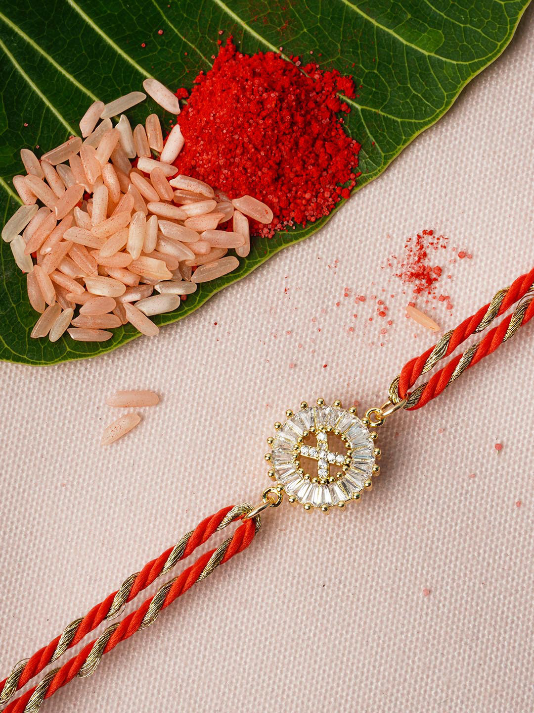 

Ferosh Gold & Red Alphabet X Rhinestone Rakhi With Roli Chawal
