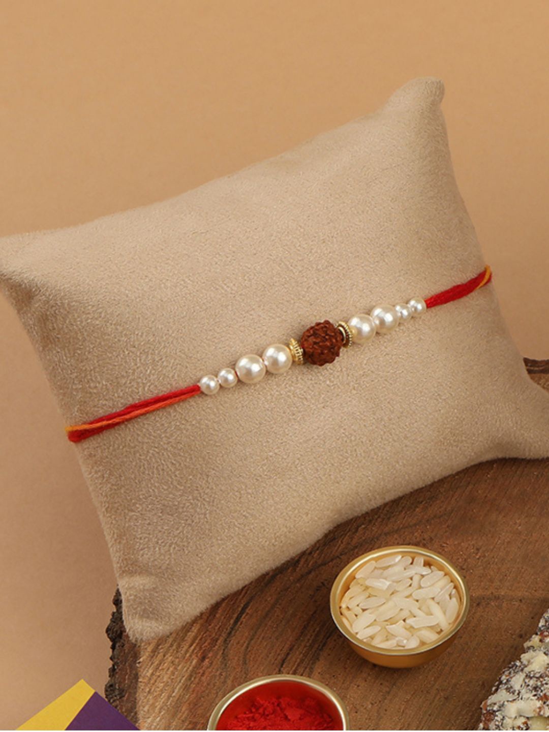 

AccessHer Red & White Pearl Studded Rudraksh Rakhi with Roli Chawal & Greetings Card