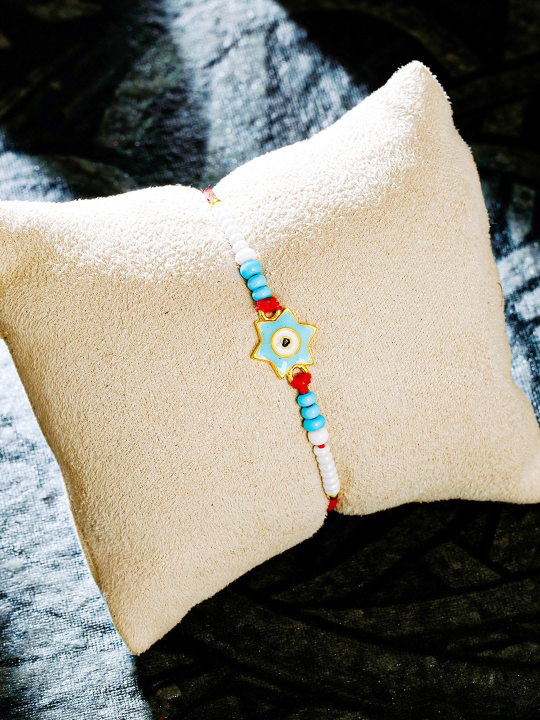 

Sukkhi Rakhi Men Gold-Plated Blue Beaded Star Rakhi