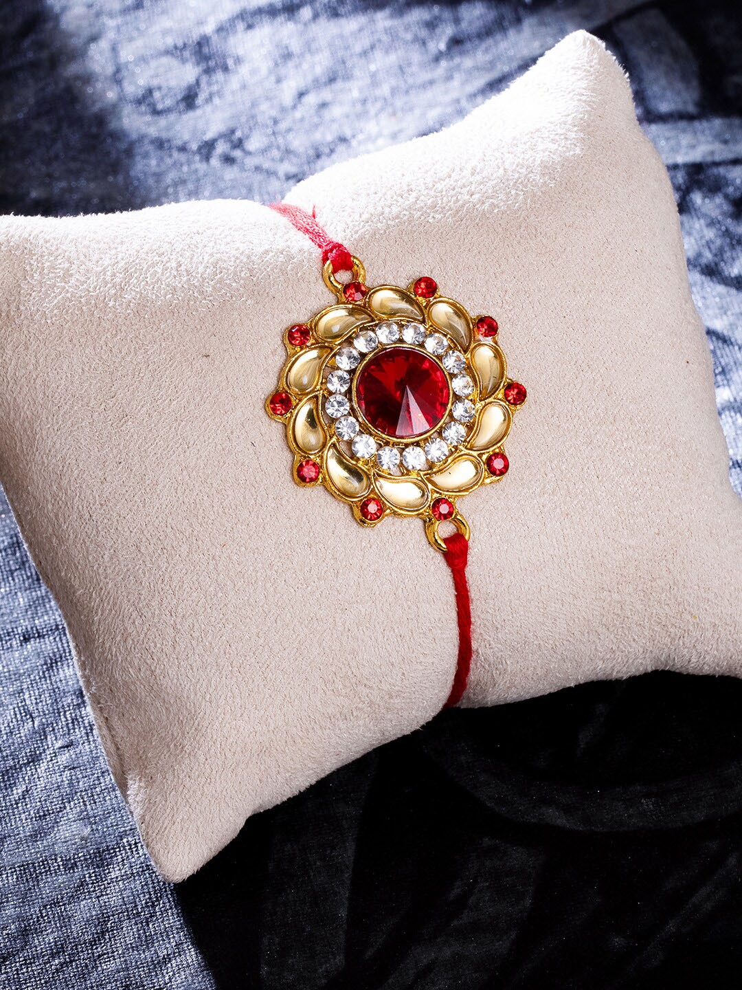 

Sukkhi Rakhi Red Gold-Plated Floral Rakhi