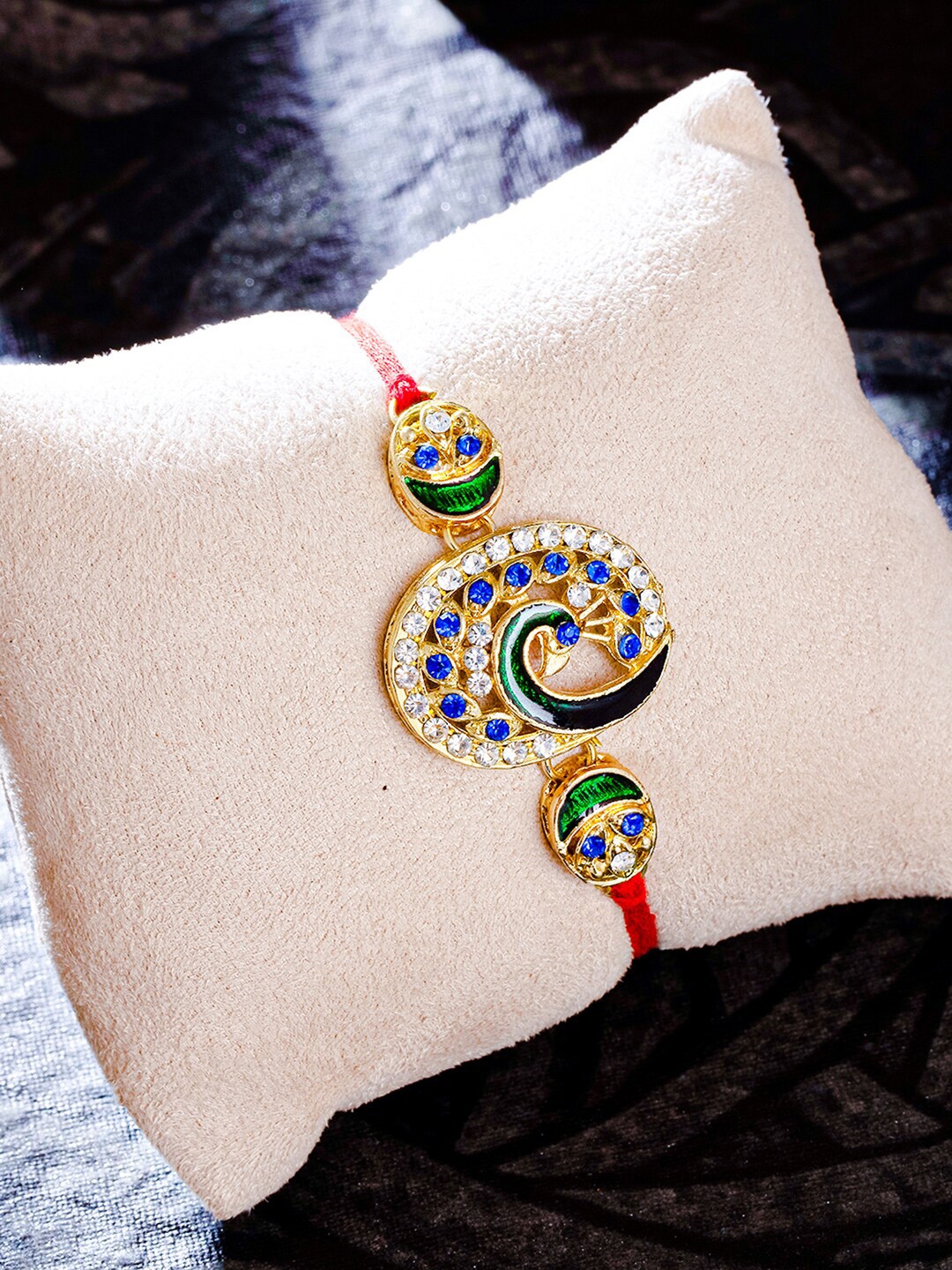 

Sukkhi Rakhi Green & Blue Gold & Plated Peacock Studded Rakhi With Roli Chawal and Greeting Card