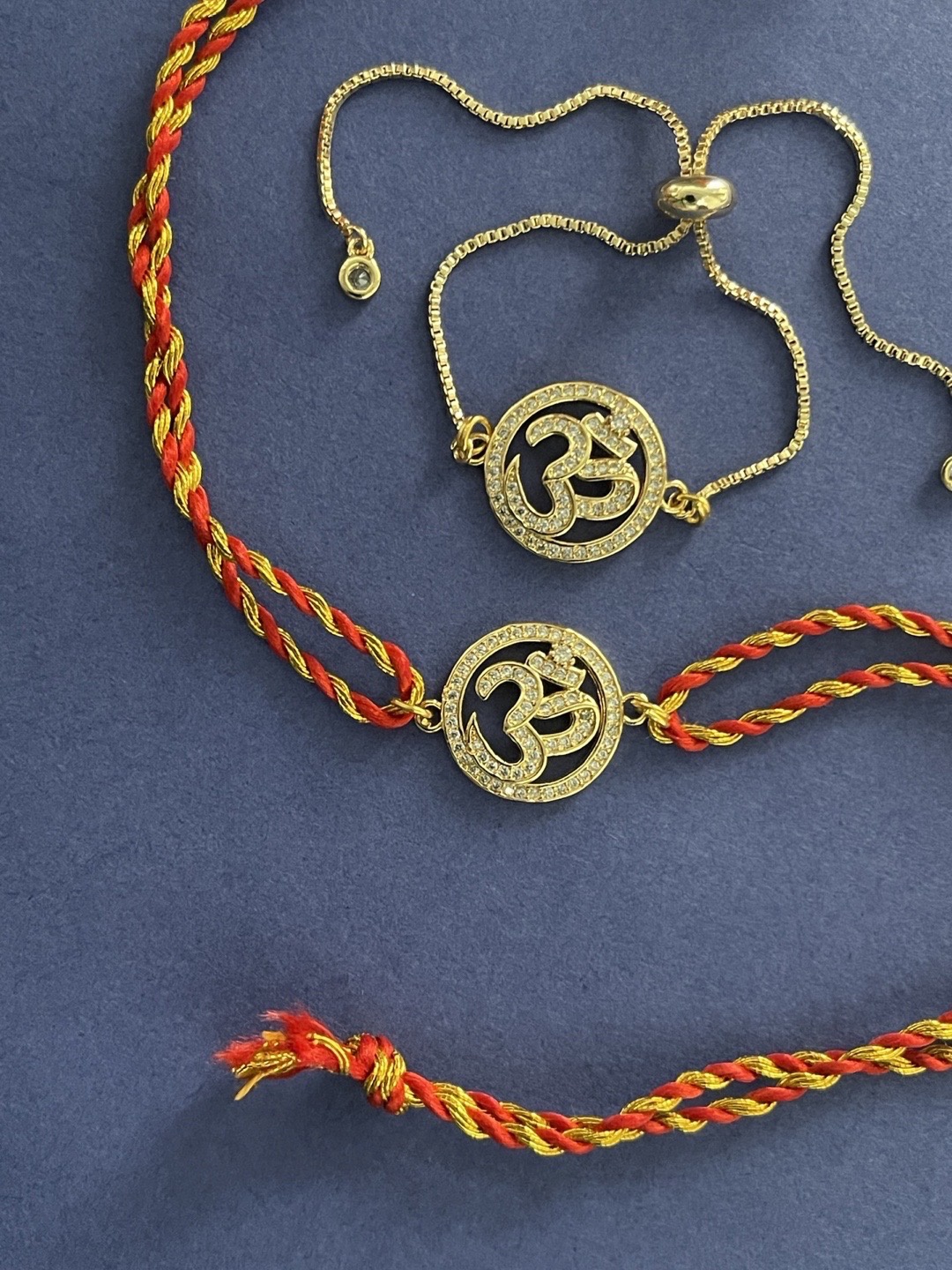 

Digital Dress Room Men Set Of 2 Gold-Plated Diamond OM Designed Rakhi