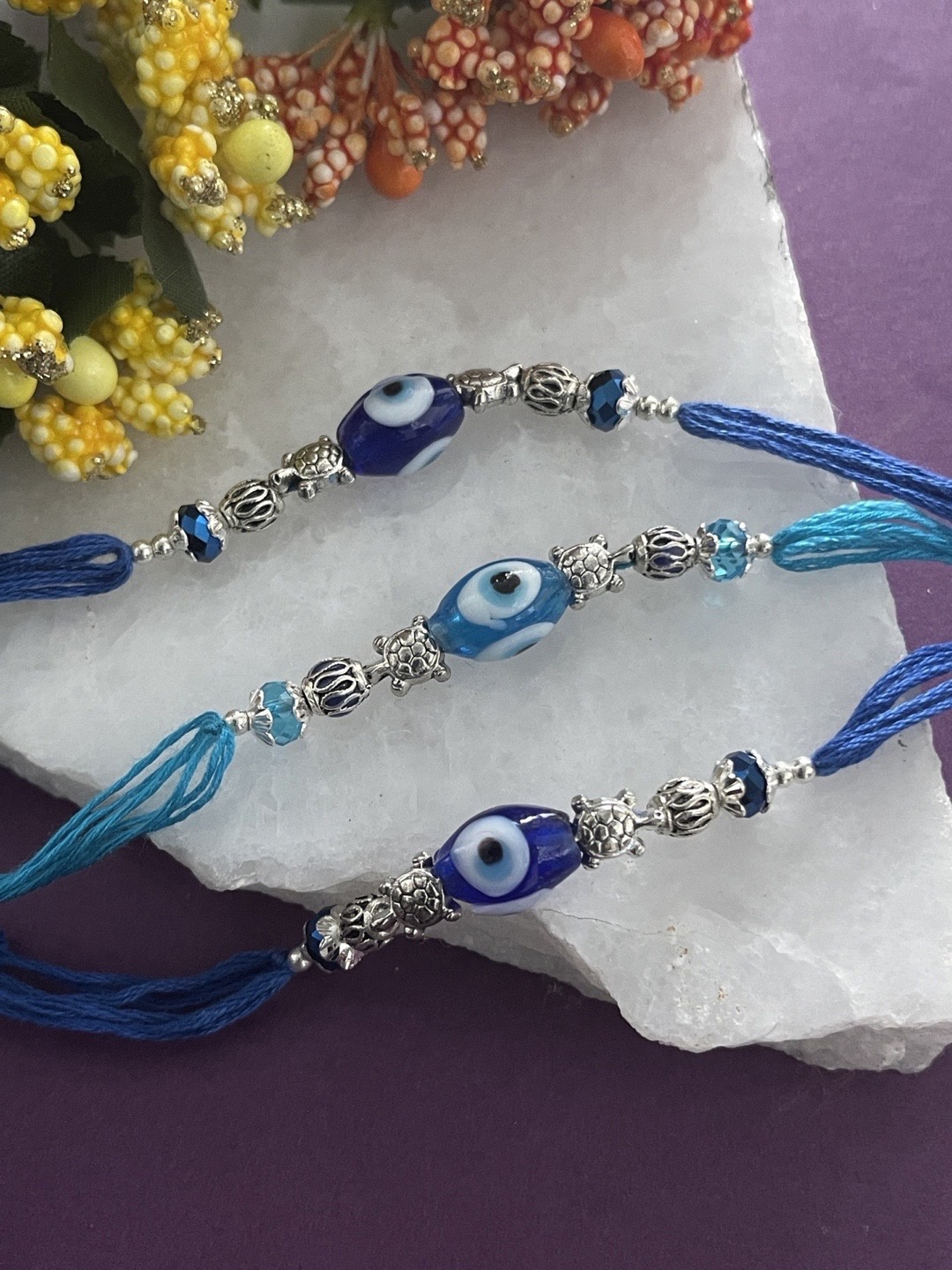 

Digital Dress Room Set Of 3 Navy Blue & Sky Blue Evil Eye Charm Rakhi