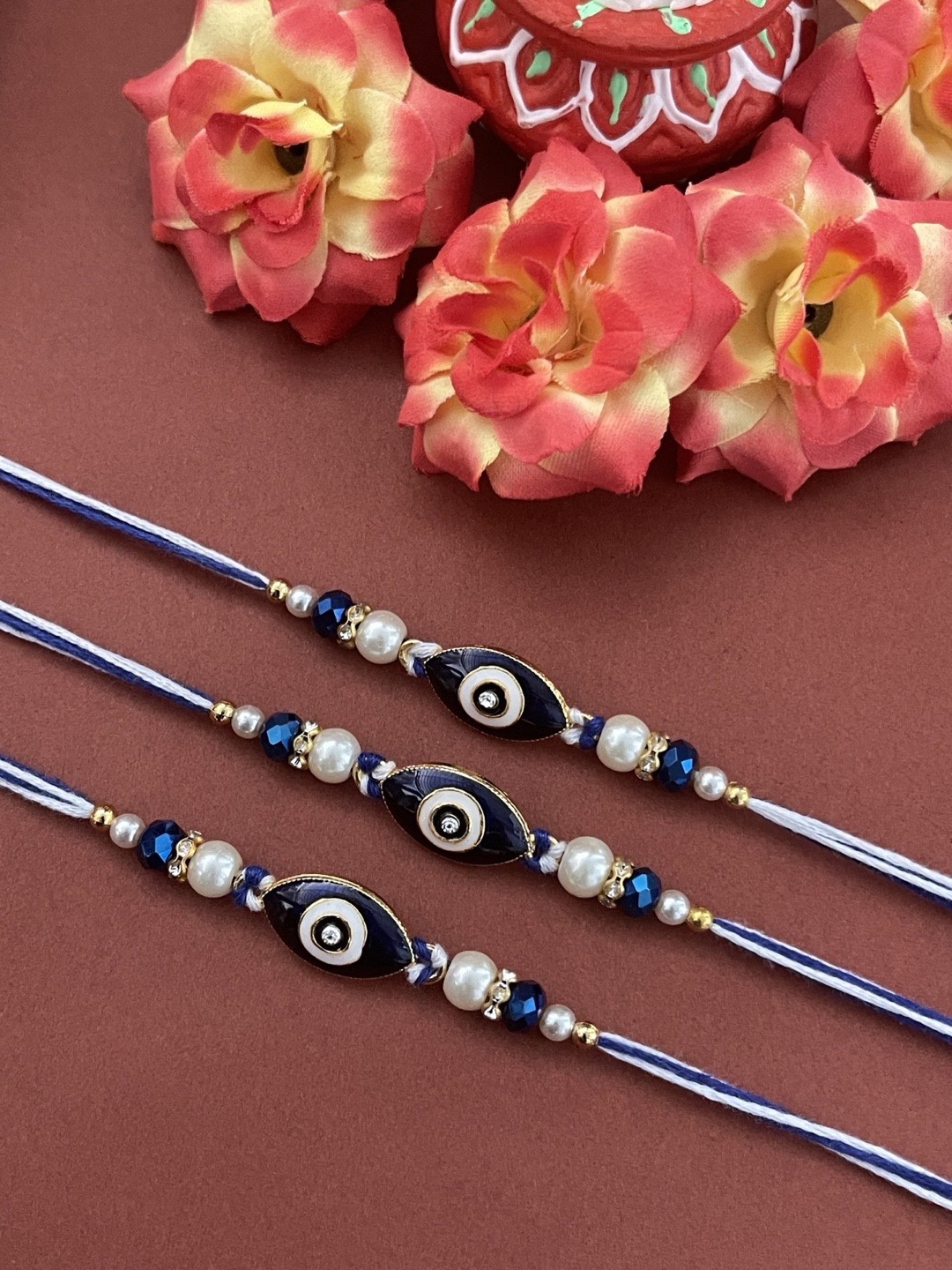 

Digital Dress Room Men Set Of 3 Gold-Toned White & Blue Stone-Studded & Beaded Evil Eye Rakhi