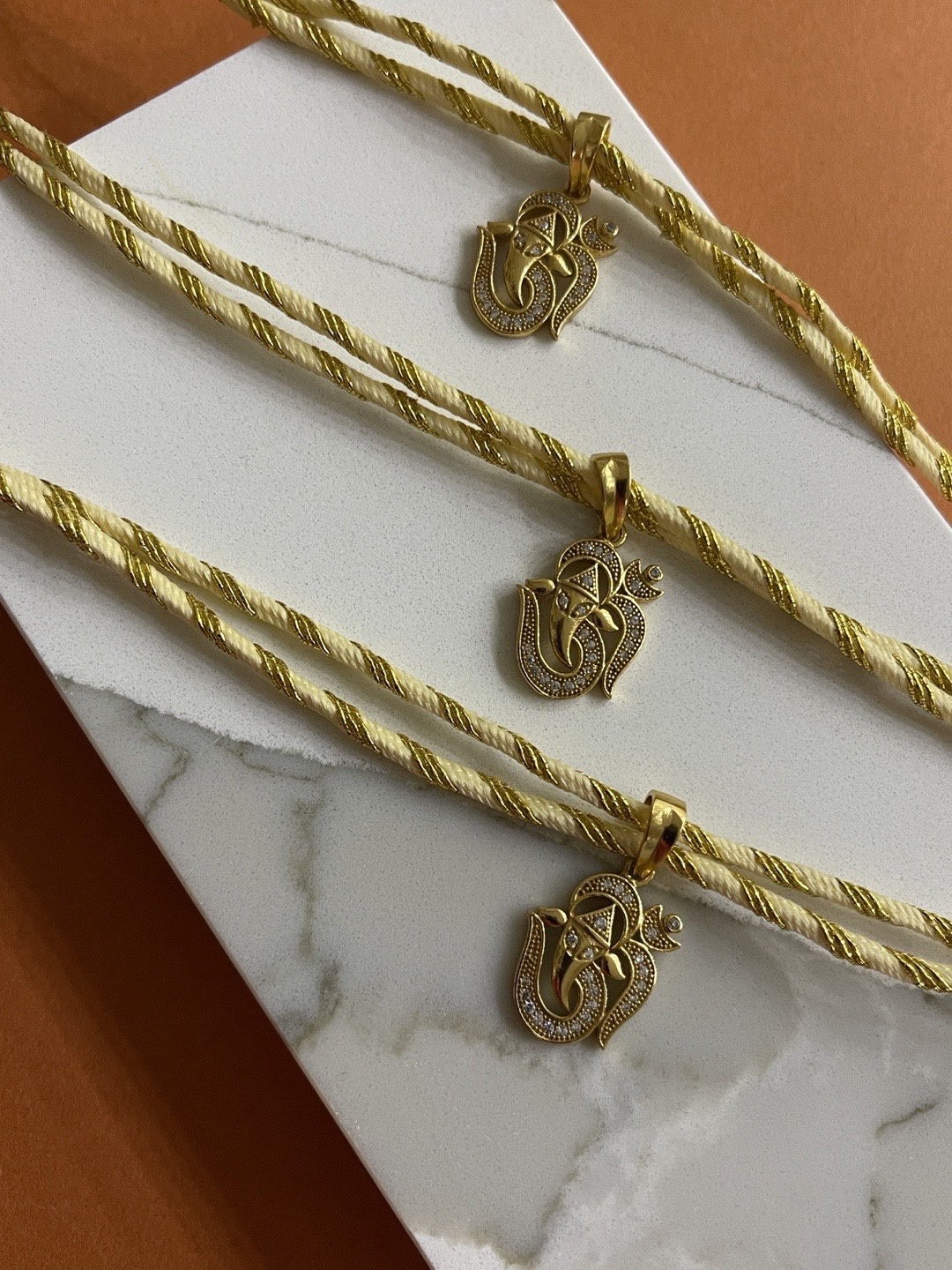 

Digital Dress Room Men Set Of 3 Gold-Plated Yellow Om-Ganesha Ad-Studded Thread Rakhi