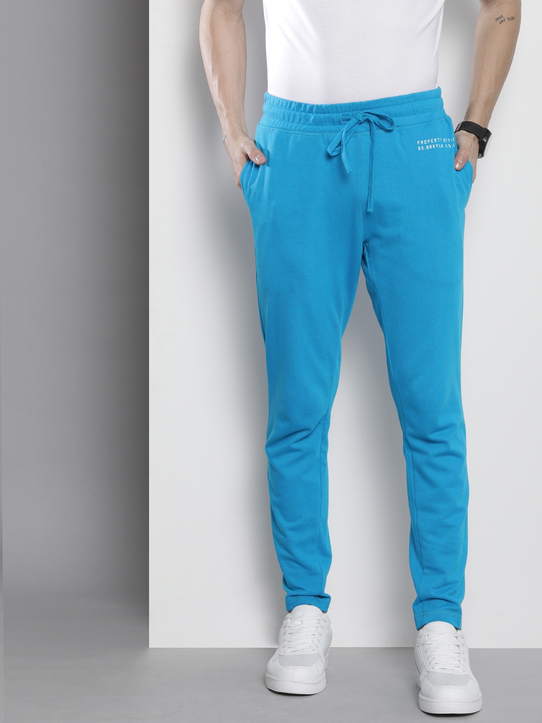 

The Indian Garage Co Men Blue Typography Printed Track Pants