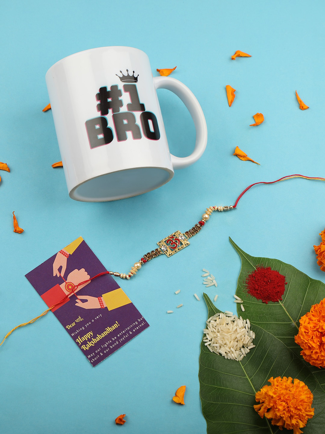 

AccessHer Women Gold Toned & Red Om Rakhi With Roli Chawal Cup & Card