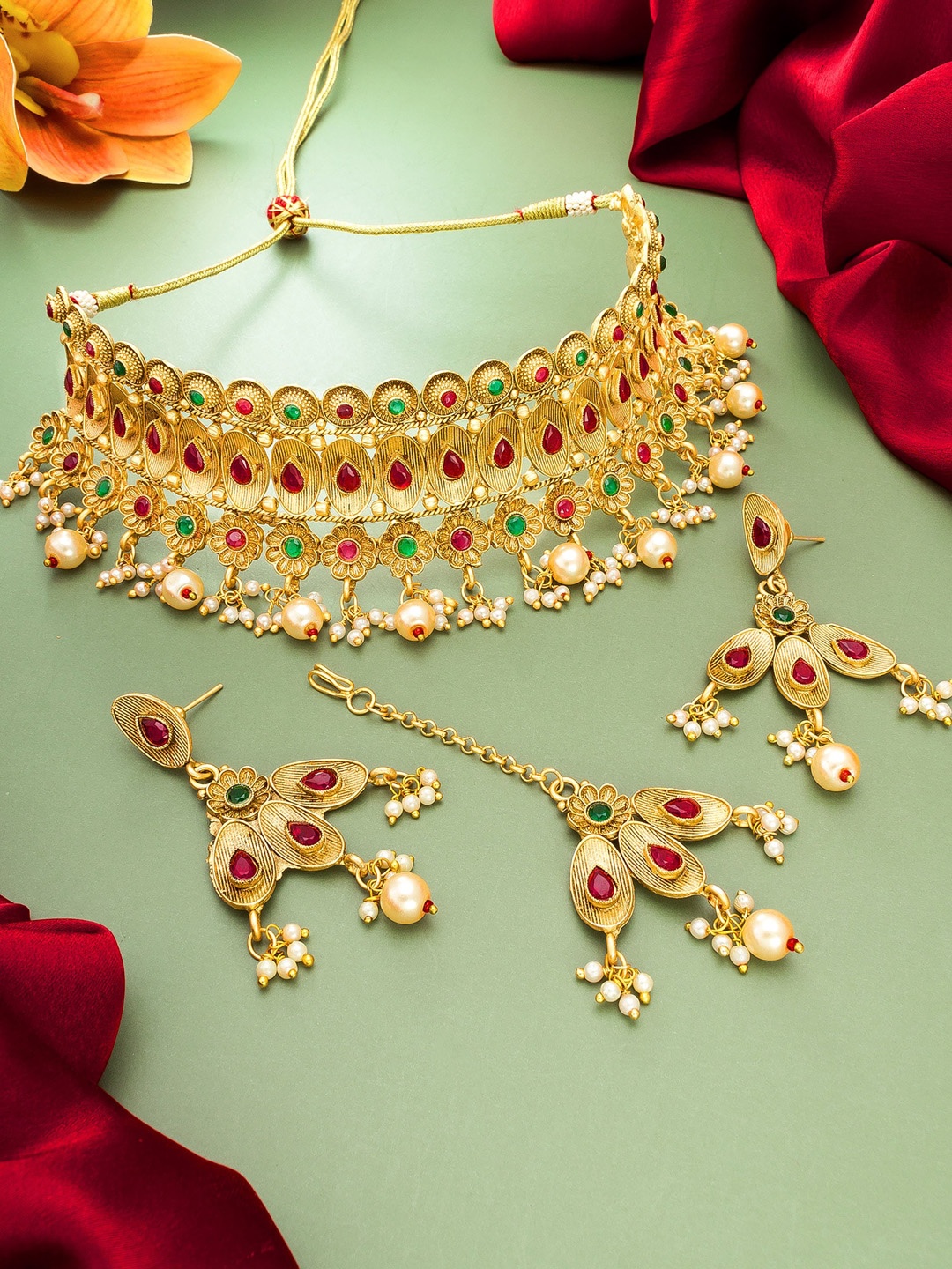 

aadita Gold-Plated & Red Stone Studded Choker Necklace with Earrings & Maang Tikka