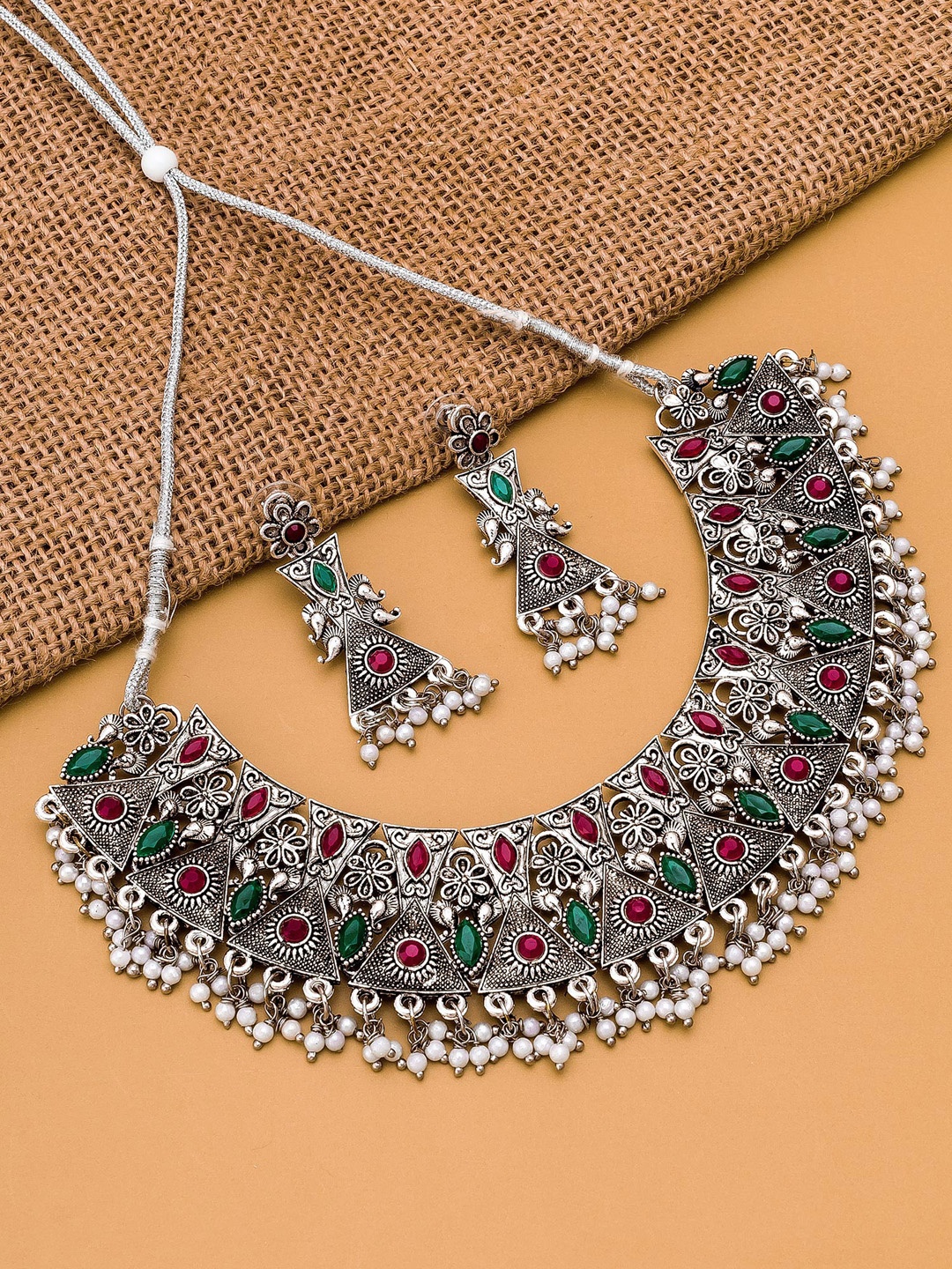 

aadita Silver-Toned Red Green & White Stone Studded Temple Jewellery Set