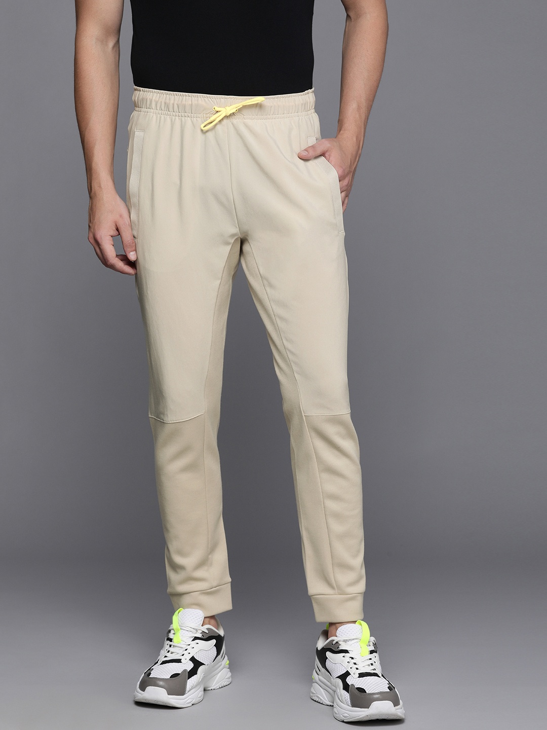 

Nike Men Beige Solid Mid Rise Dry Fit Casual Joggers
