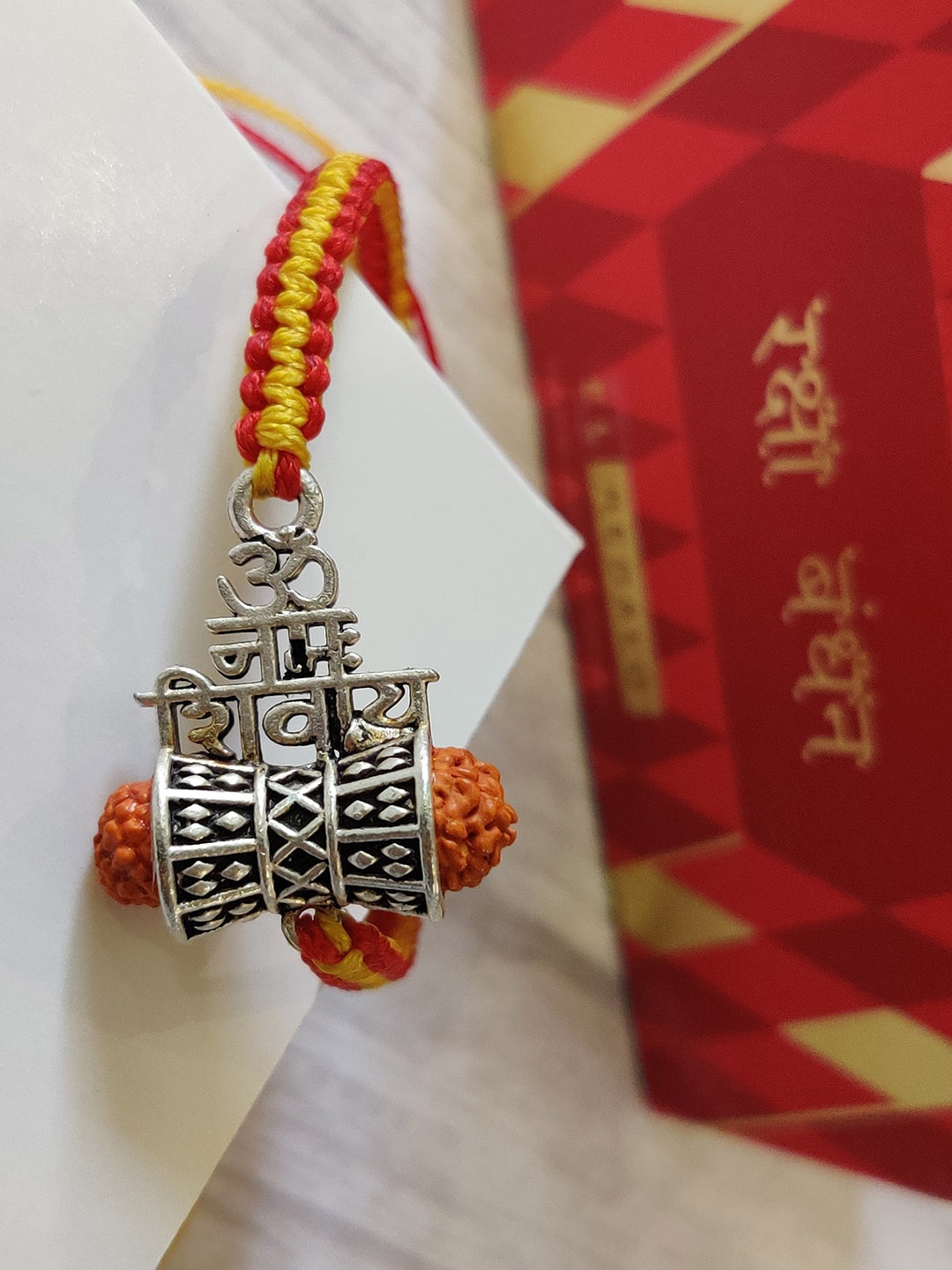 

EL REGALO Men Orange & Silver-Toned Rakhi