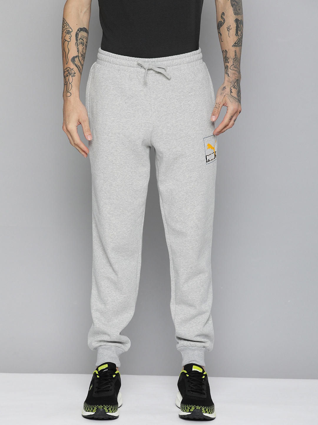 

Puma Men Brand Logo Printed Mid-Rise Regular Fit Brand Love Regular Joggers, Grey melange