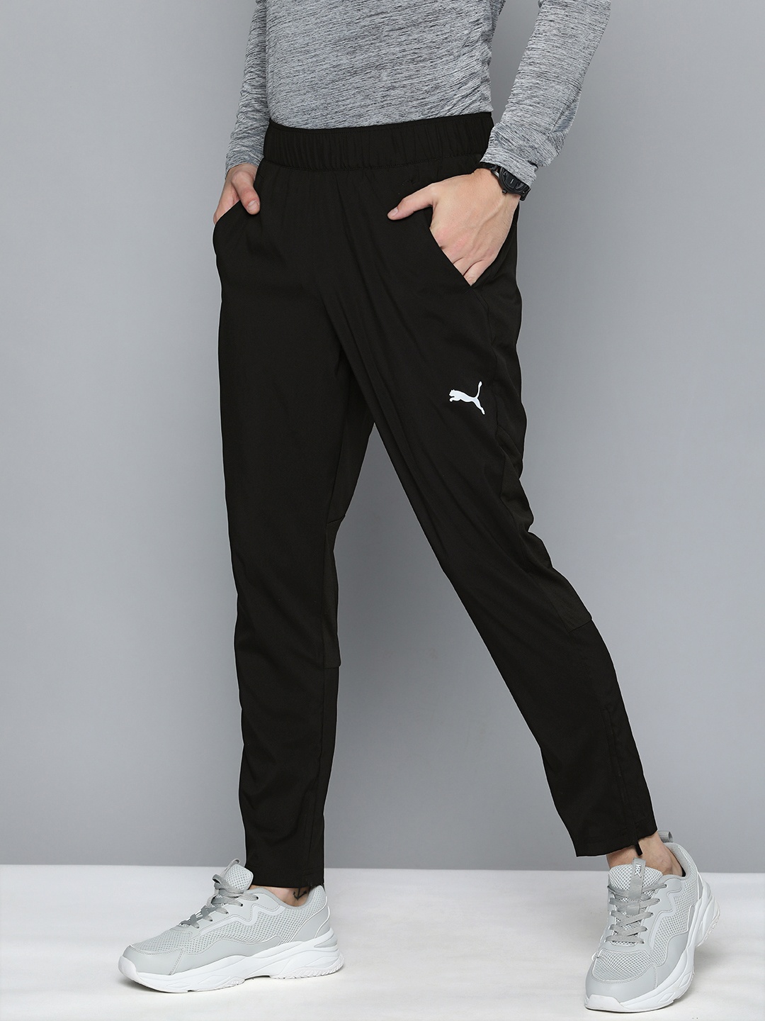 

Puma Men Black Solid Mid Rise DRYCELL Regular Woven Running Track Pants