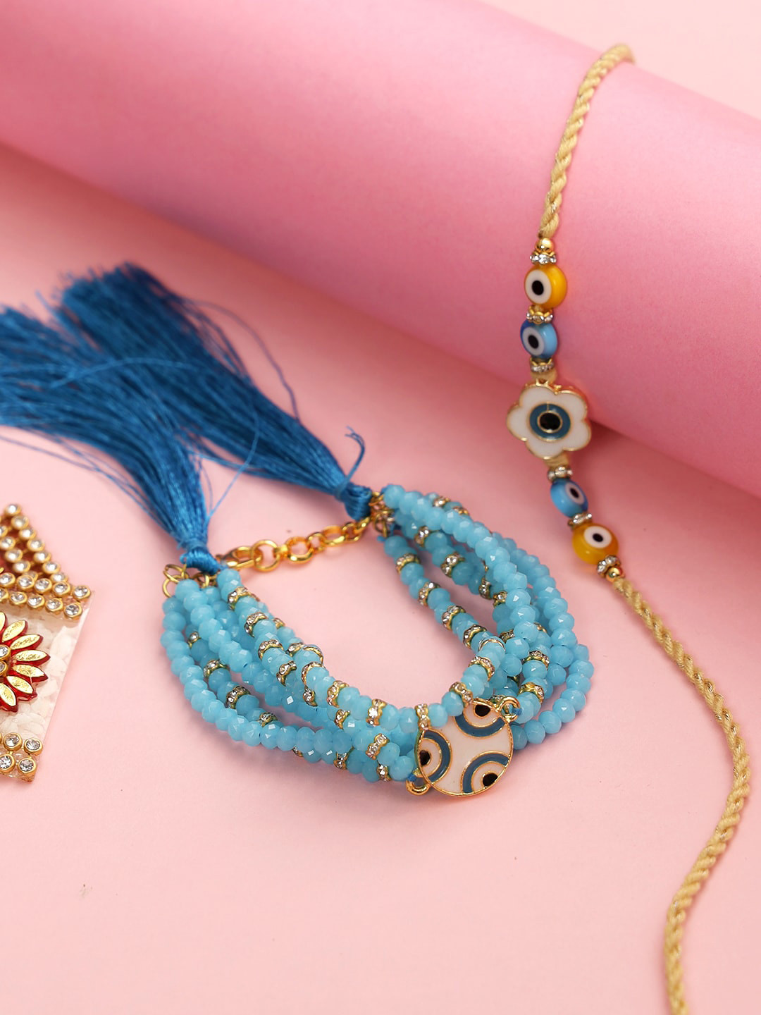 

Aapno Rajasthan Set Of 2 Blue & White Beaded & Evil-Eye Charm Rakhi & Lumba With Roli Rice & Greeting Card