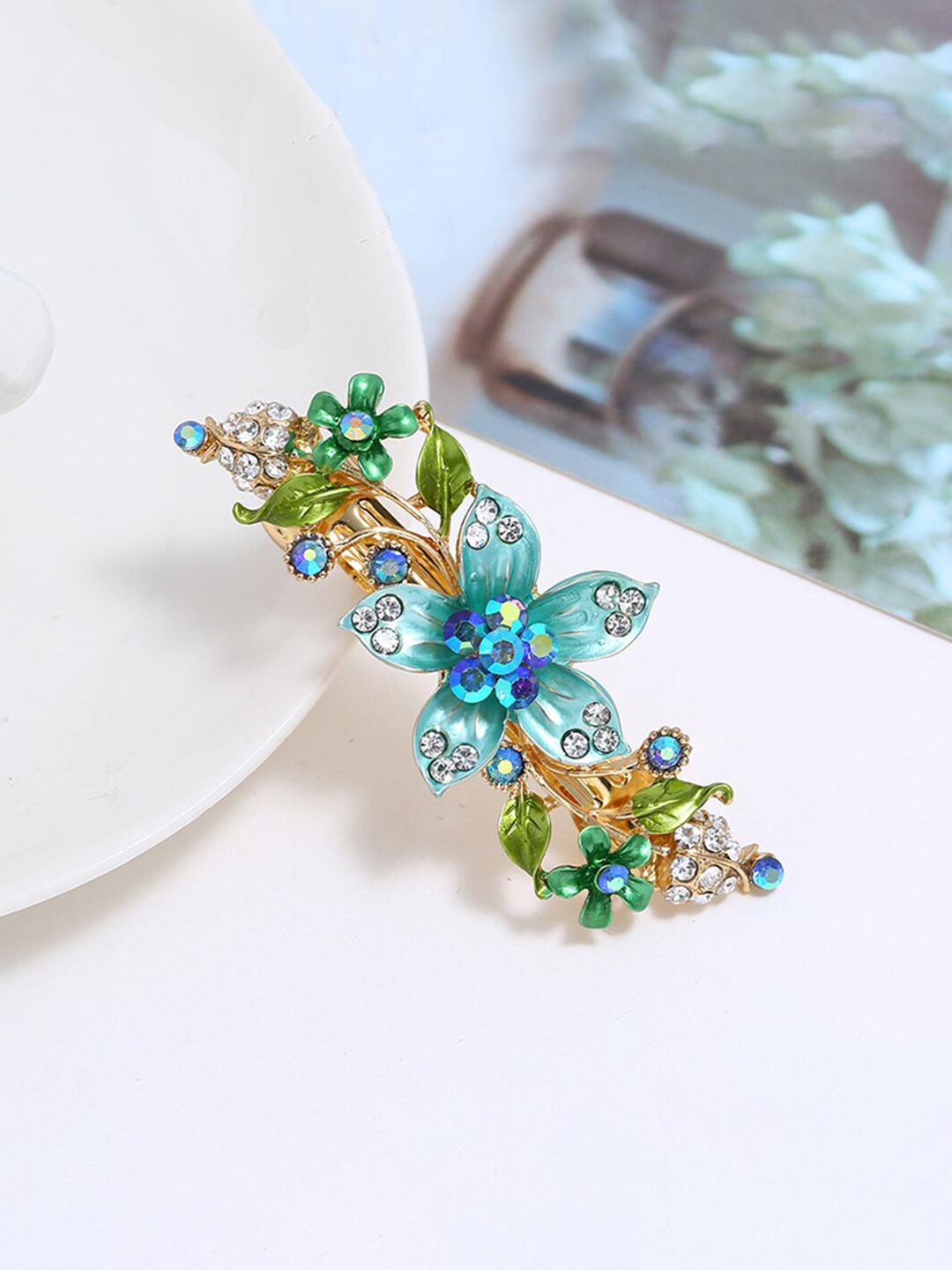 

Yellow Chimes Gold Toned & Blue Floral Designed Crystal Studded French Baratte Hair Clip