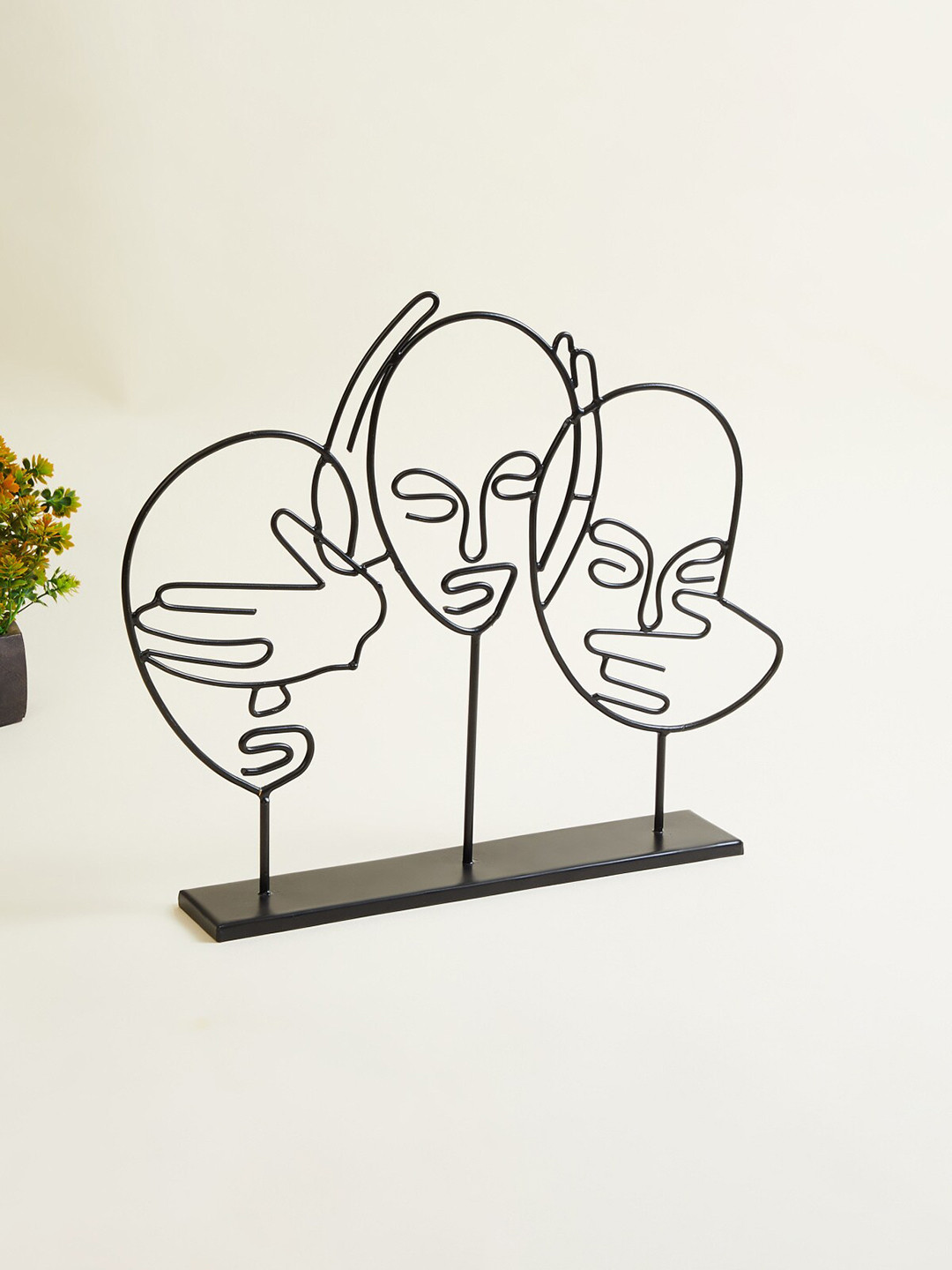 

Home Centre Black Textured Metal Human Face Table Showpiece