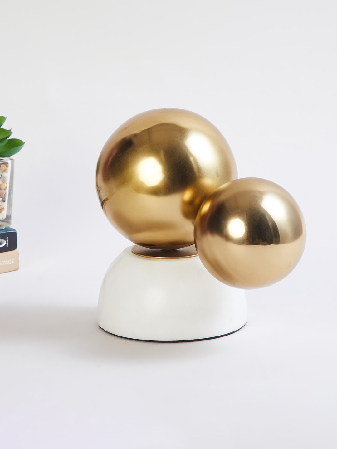 

Home Centre Gold-Toned and White Eternity Berlin Solid Round Ball Metal Table Decor