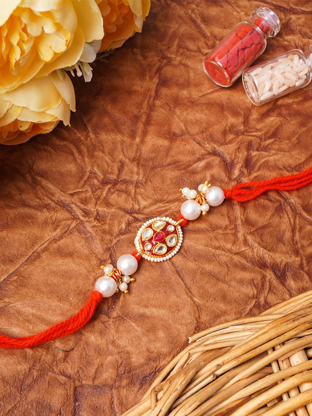 

Urmika White & Red Kundan Beaded Thread Rakhi
