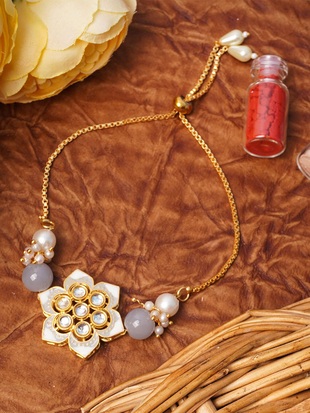 

Urmika White and Gold-Plated Rakhi with Roli Chawal