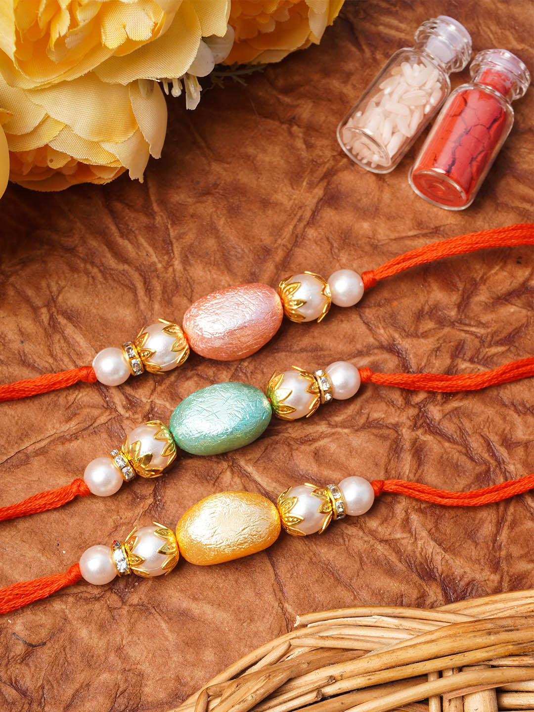 

Urmika Set Of 3 Beaded Thread Rakhis with roli & chawal, Pink