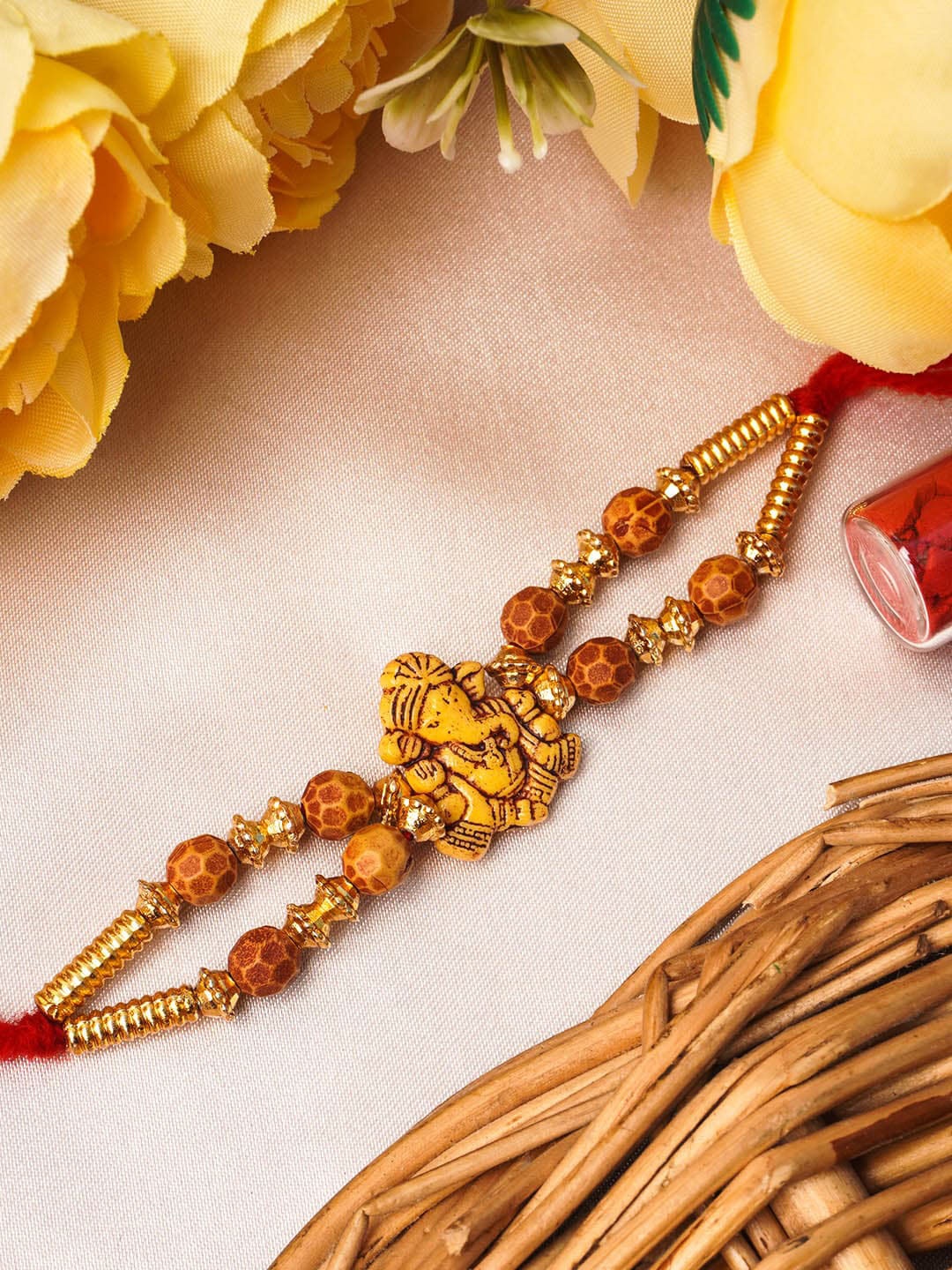 

Urmika Yellow Lord Ganesh Rakhi With Roli Chawal
