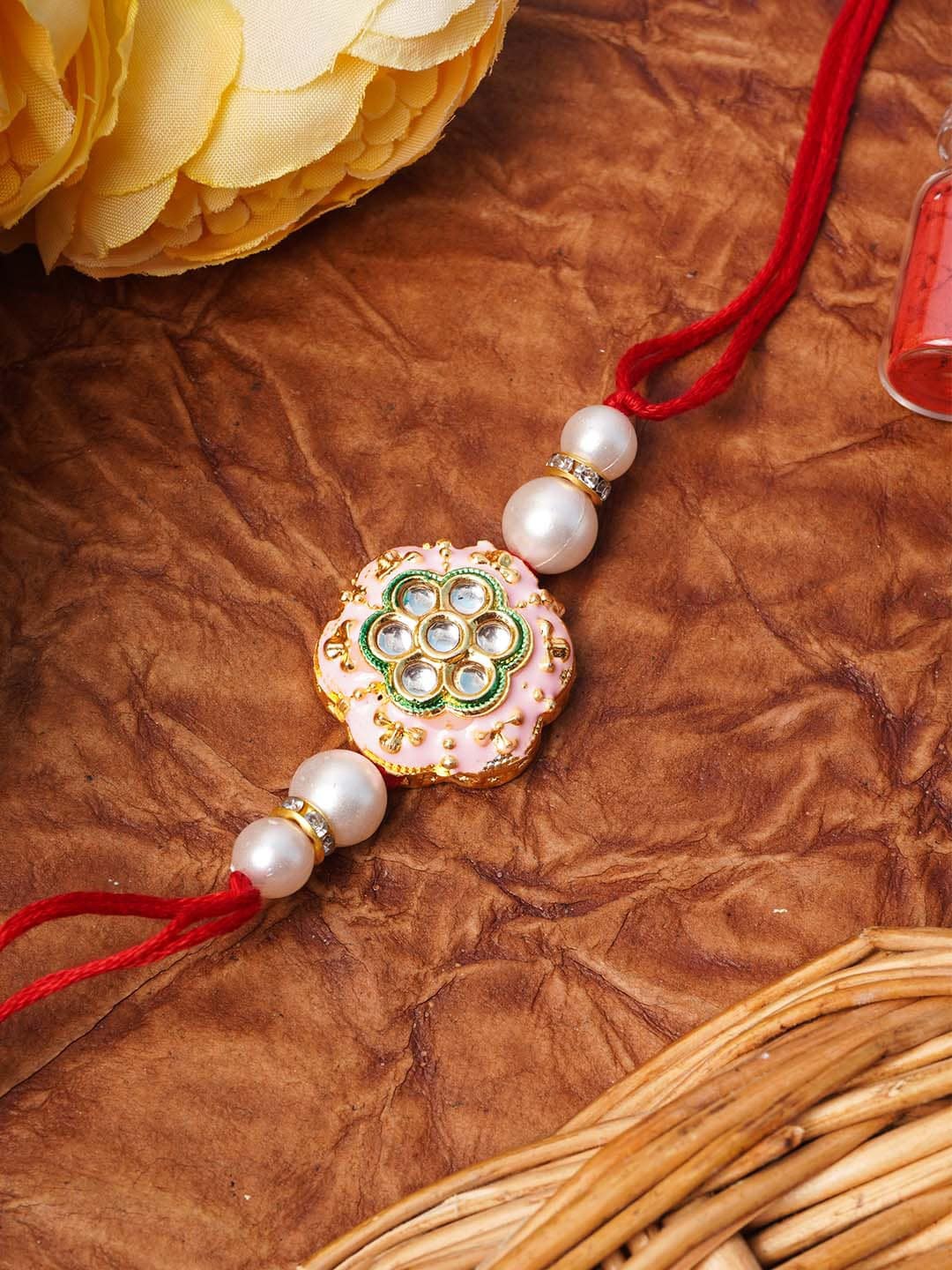 

Urmika Pink & Off-White Meenakari Kundan Studded Rakhi with Roli Chawal