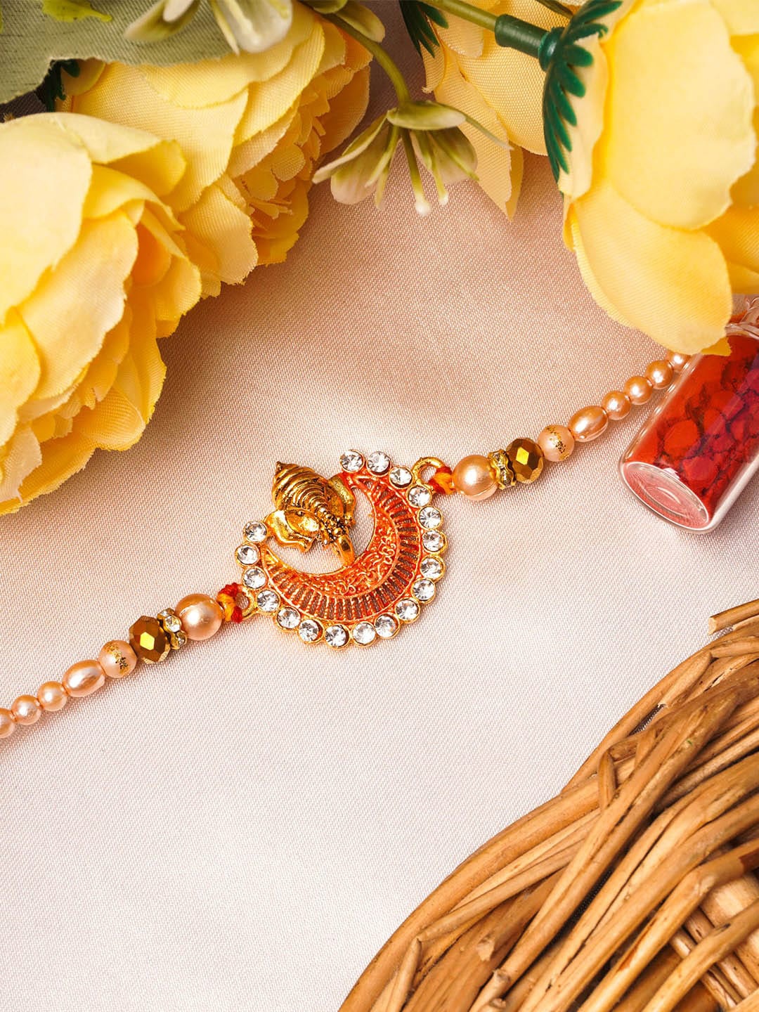 

Urmika Red and Gold Toned Ganesh Bhaiya Rakhi