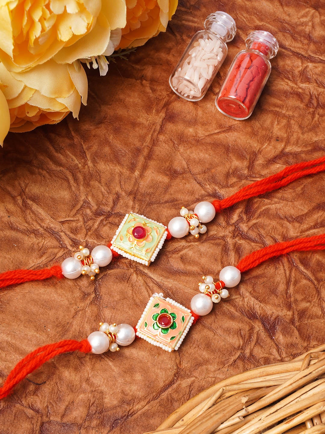 

Urmika Set Of 2 Meenakari Red & Gold-Toned Stone-Studded Rakhis with Roli and Chawal