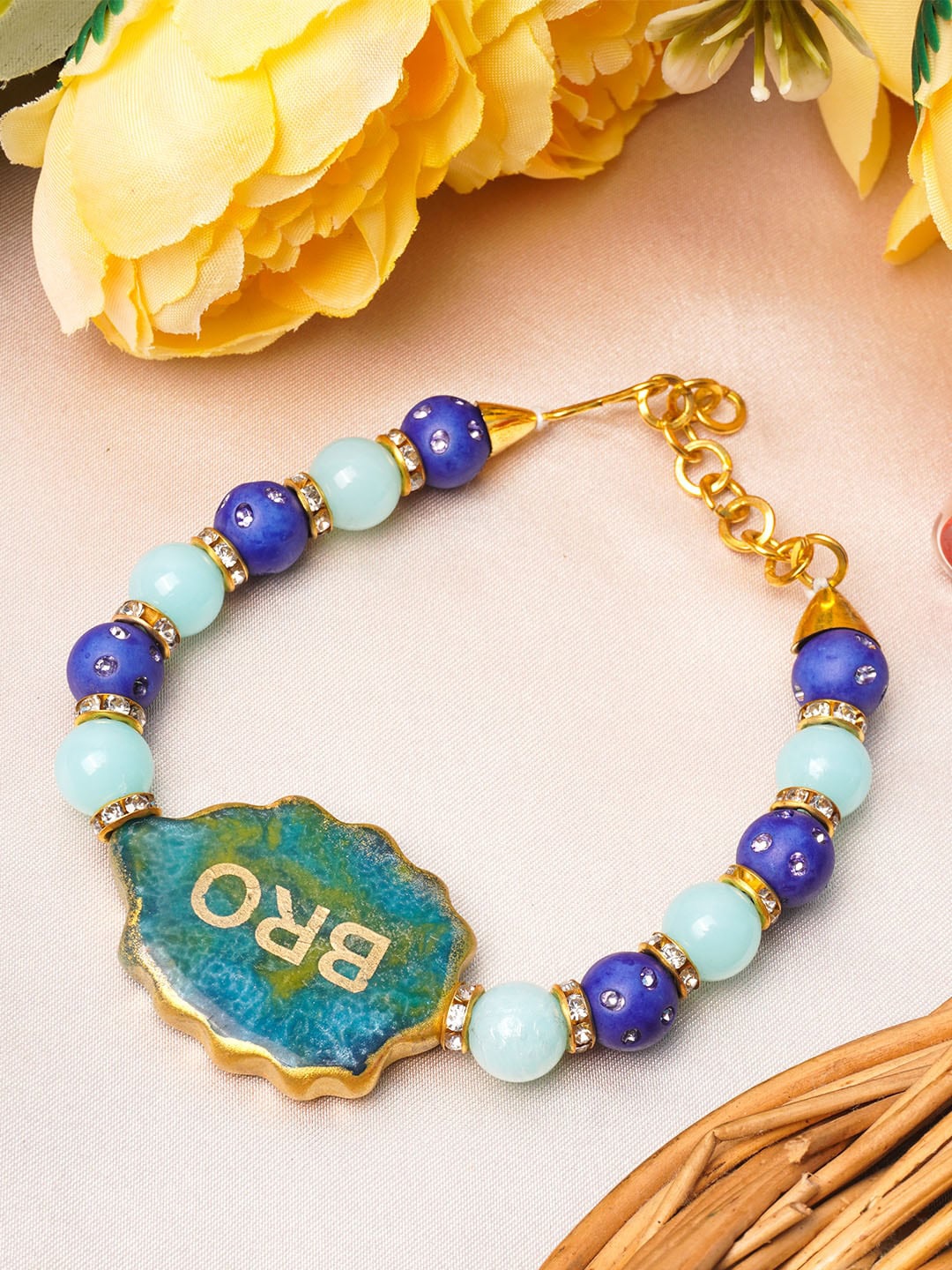 

Urmika Blue & Turquoise Blue Beaded Rakhi With Roli & Chawal
