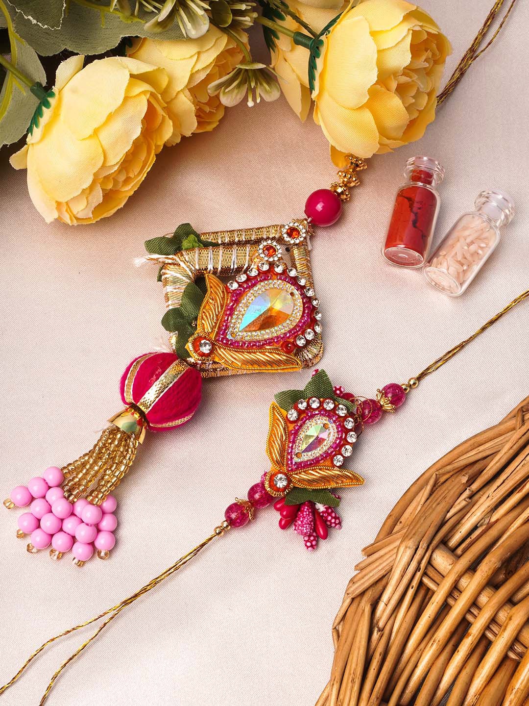 

Urmika Set of 2 Gold-Toned White & Pink Stone-Studded & Beaded Rakhi with Roli Chawal
