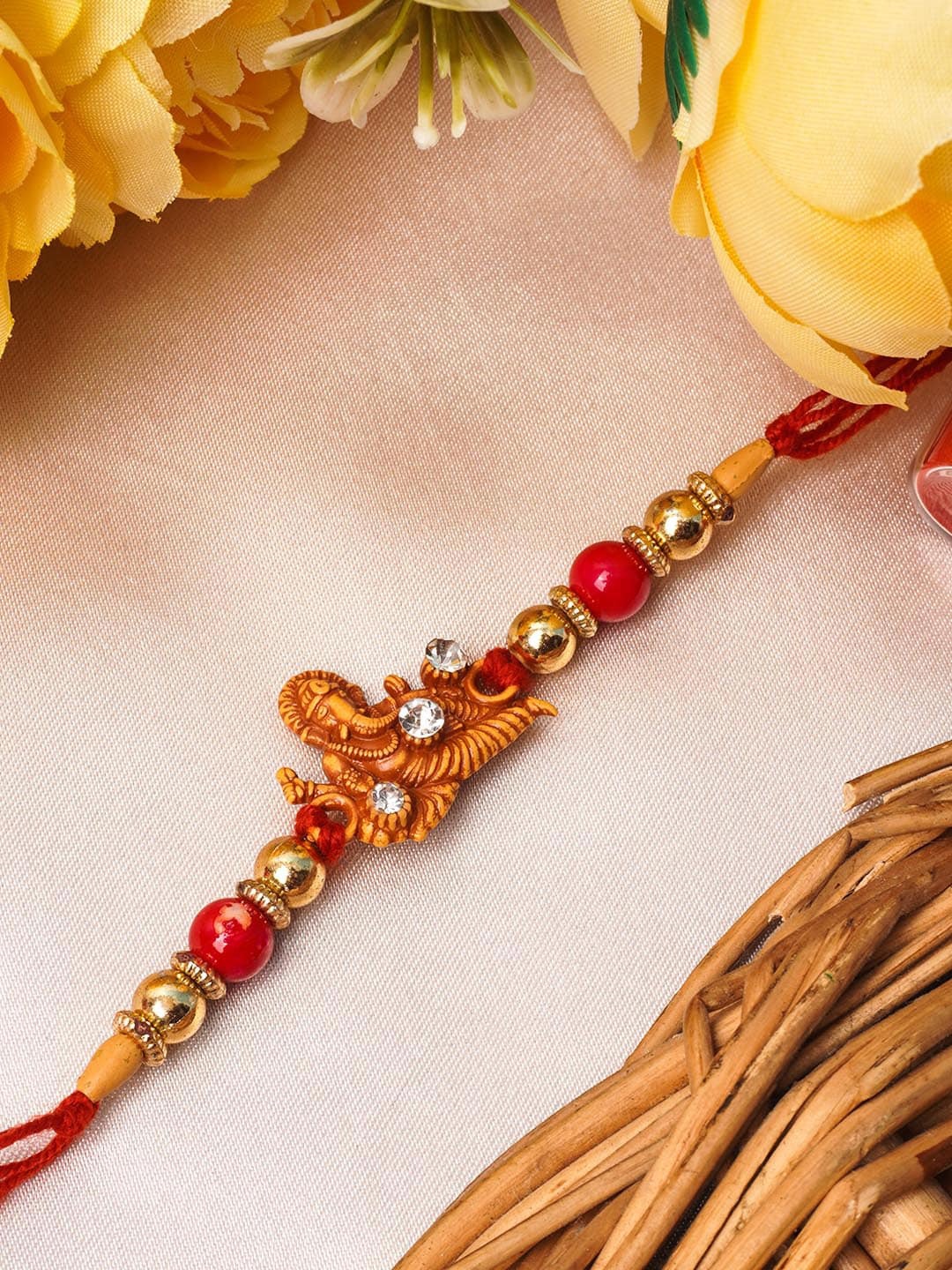 

Urmika Red & Gold-Toned Ganesh Ji Beaded Thread Rakhi