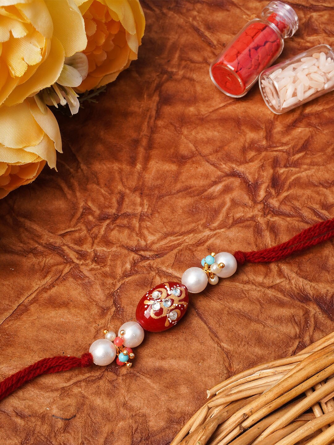 

Urmika Unisex Red Pearl & Beads Rakhi With Roli & Chawal