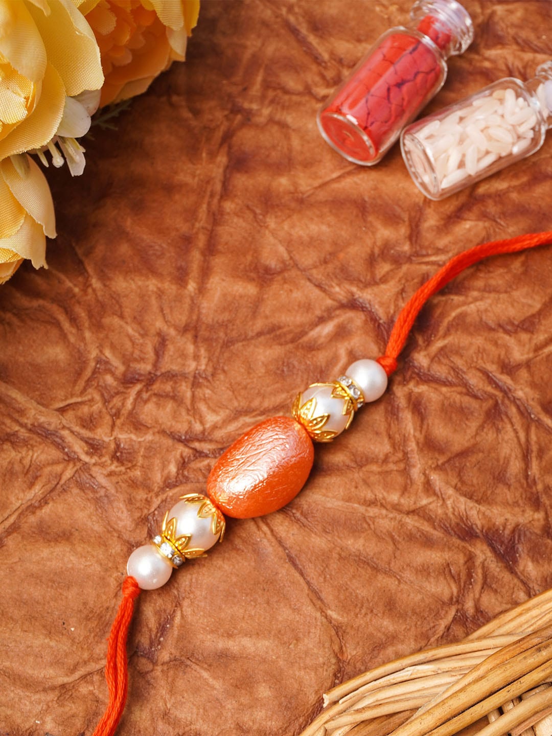 

Urmika Orange & Gold-Toned Beaded Thread Rakhi