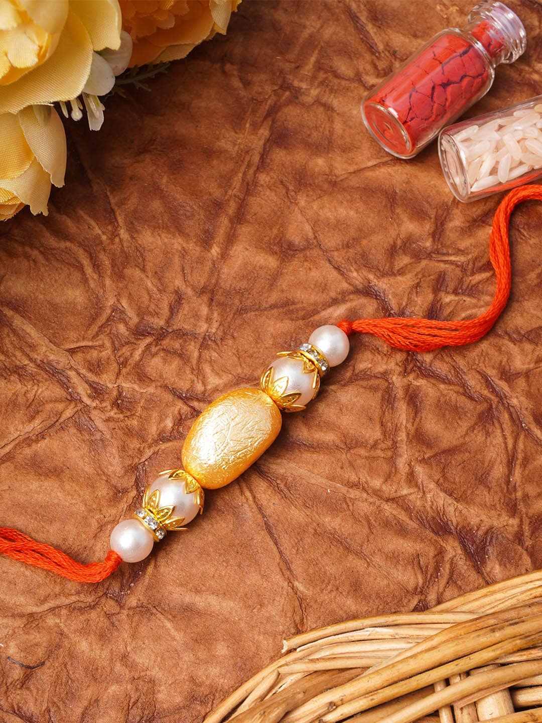 

Urmika Orange Beaded Pearl Rakhi