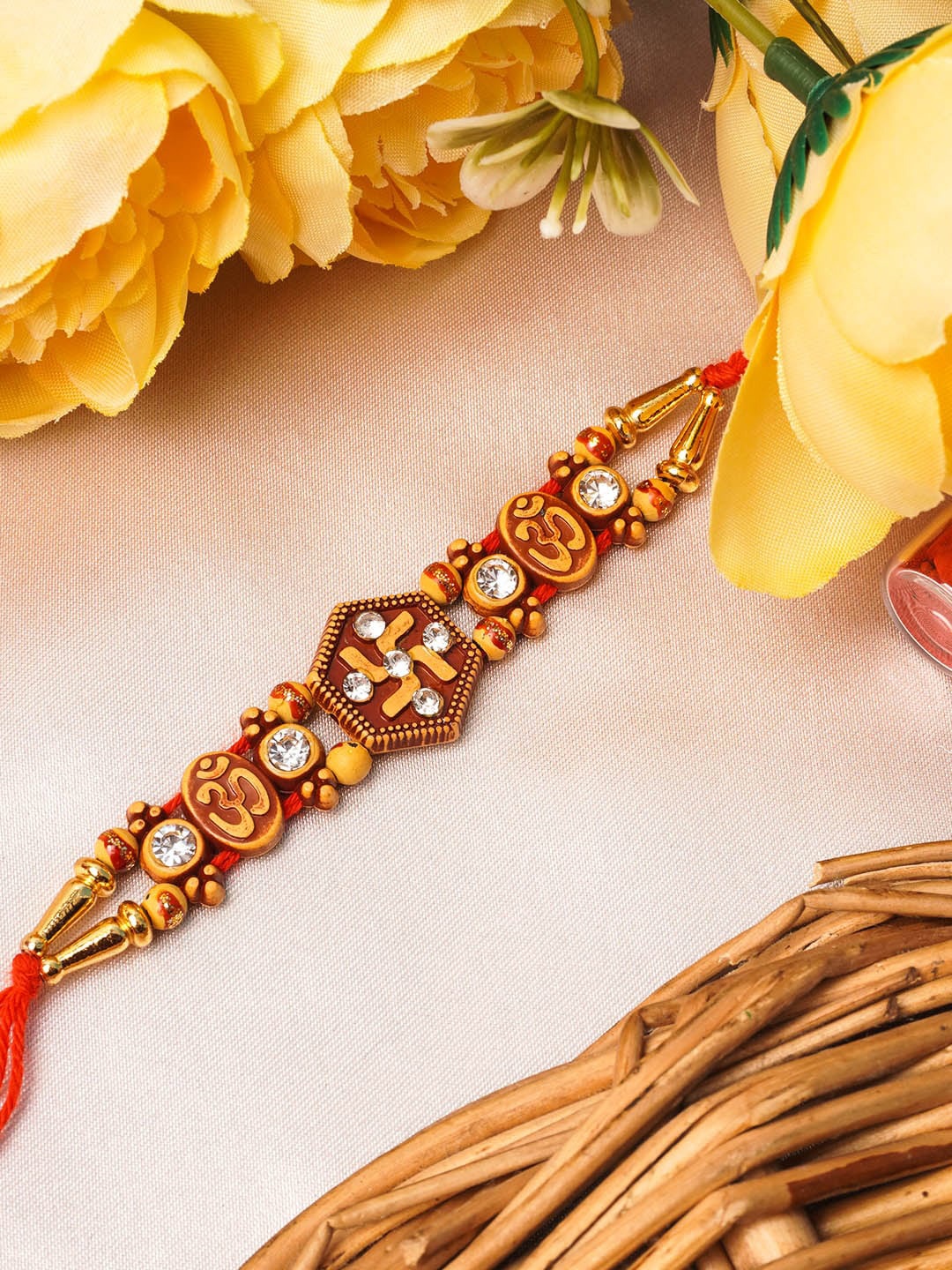 

Urmika Yellow Swastik Om Beaded Thread Rakhi