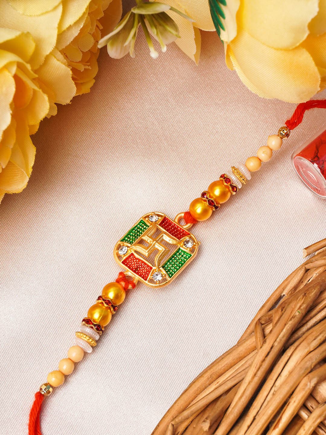 

Urmika Gold-Toned & Red Swastik In Square Rakhi with Roli Chawal