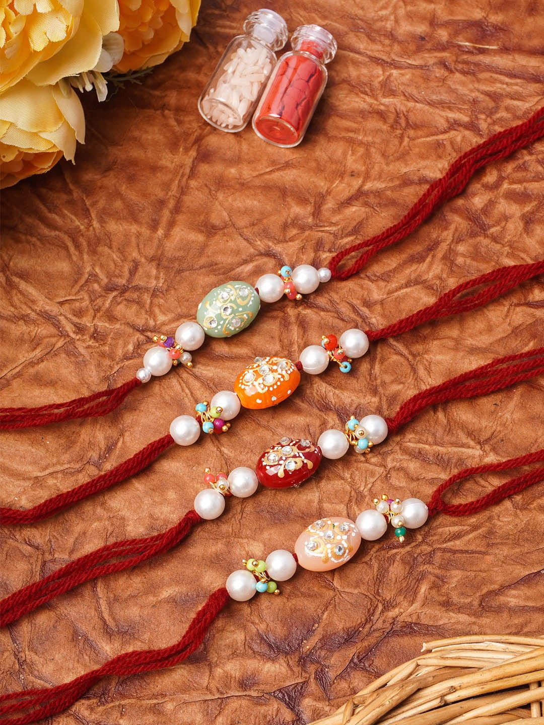 

Urmika women Set of 4 Pearl & Beads Rakhi with Roli and Chawal, Multi