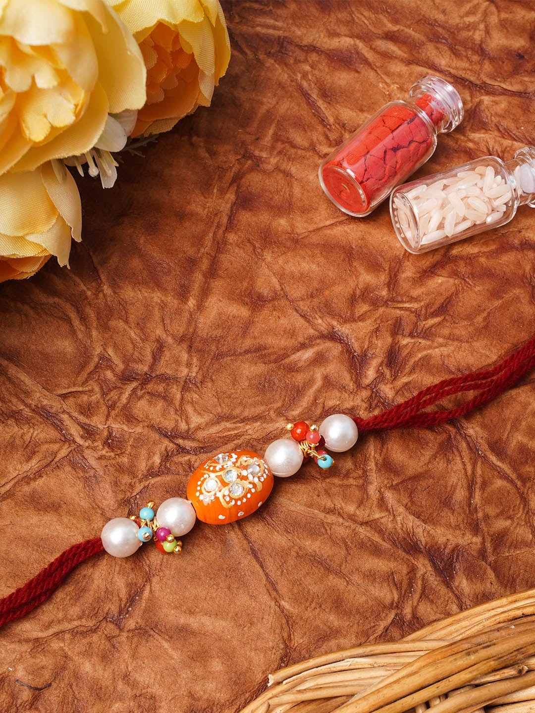 

Urmika Orange Beaded Thread Rakhi