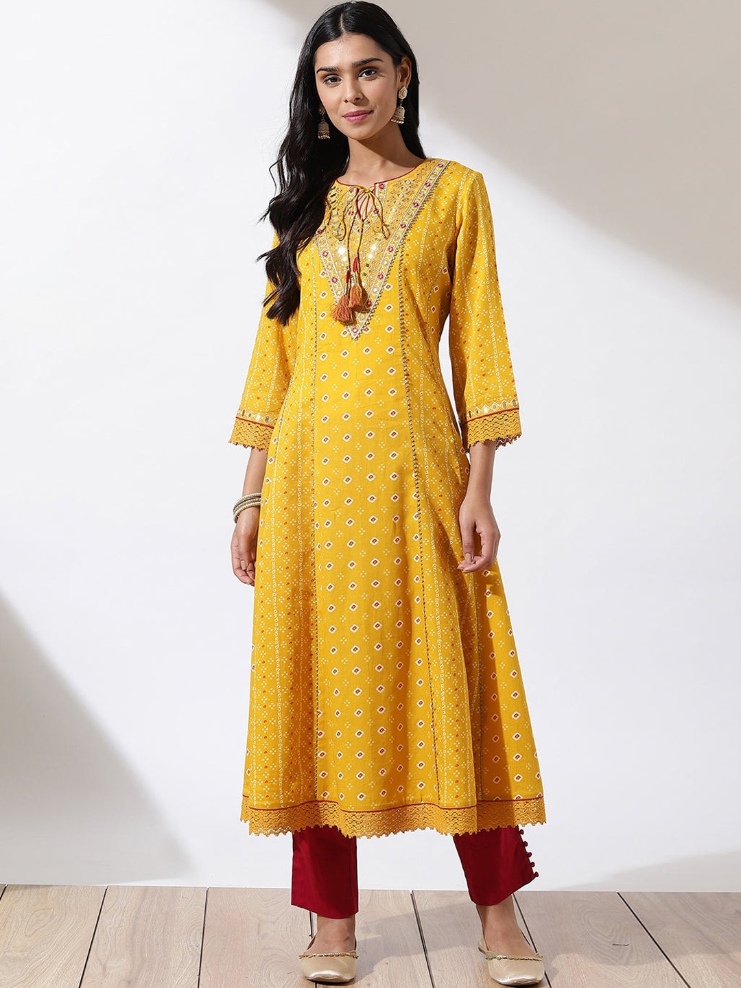 

Lakshita Women Yellow Printed Tie Neck Mirror Work Gotta Patti Kurta