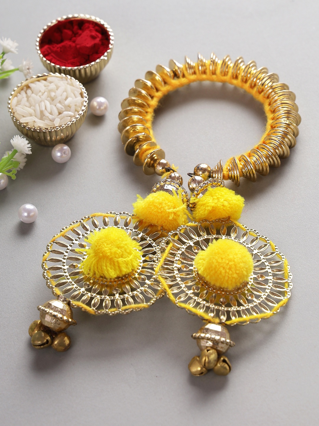 

Aapno Rajasthan Women Yellow & Gold-Toned Beaded Lumba Rakhi With Roli Chawal & Card