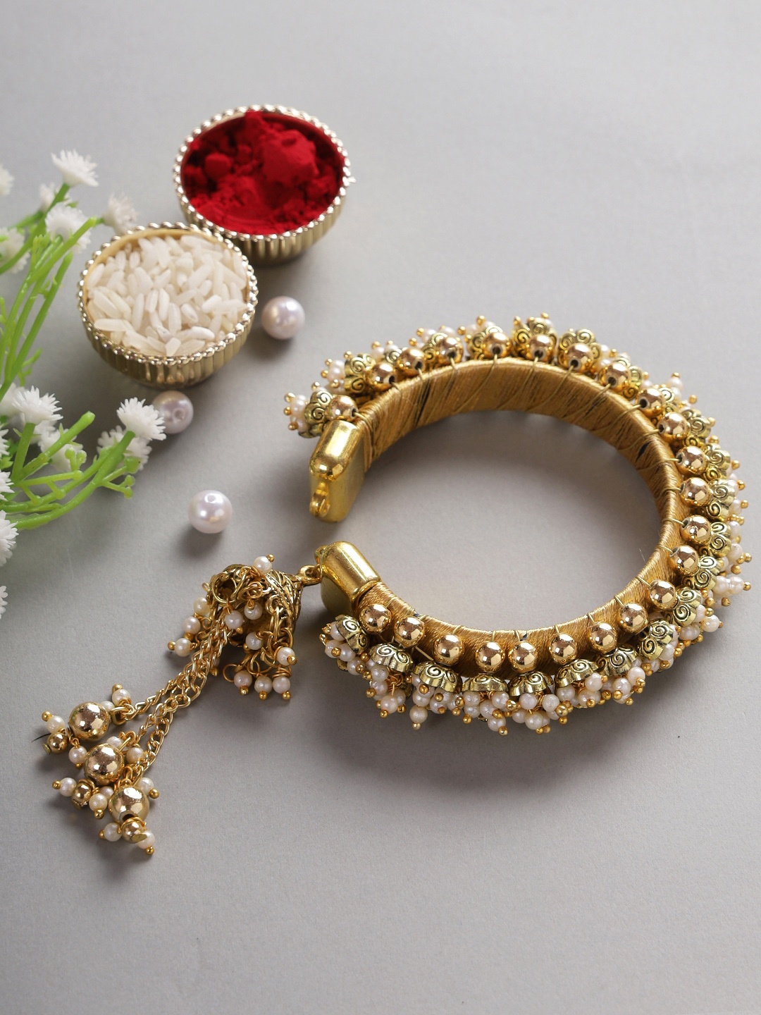 

Aapno Rajasthan Women Gold-Toned Lumba Bracelet Rakhi