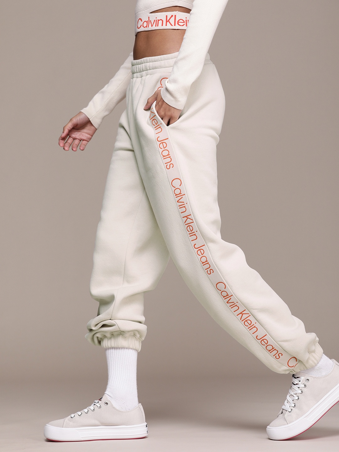 

Calvin Klein Jeans Women Beige Solid Relaxed Fit Joggers With Printed Sides