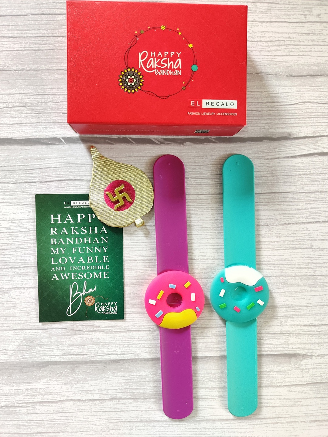 

EL REGALO Kids Set of 2 Donut Shaped Rakhis With Greeting Card & Roli Chawal, Red