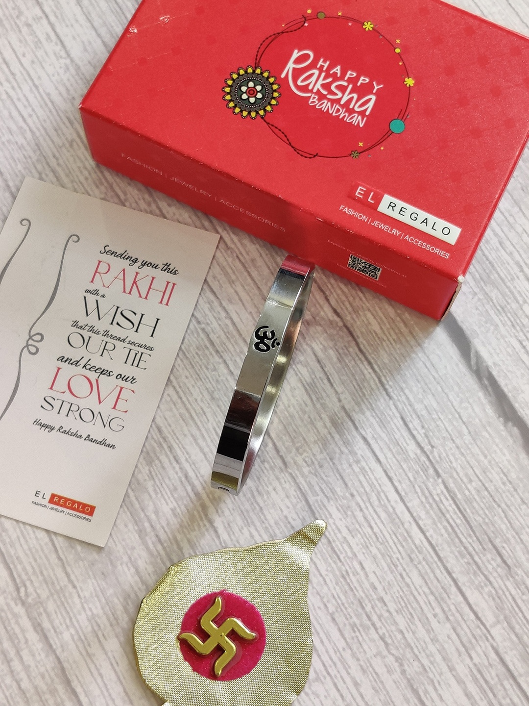 

EL REGALO Silver-Plated OM Stainless Steel Kada Rakhi With Greeting Card