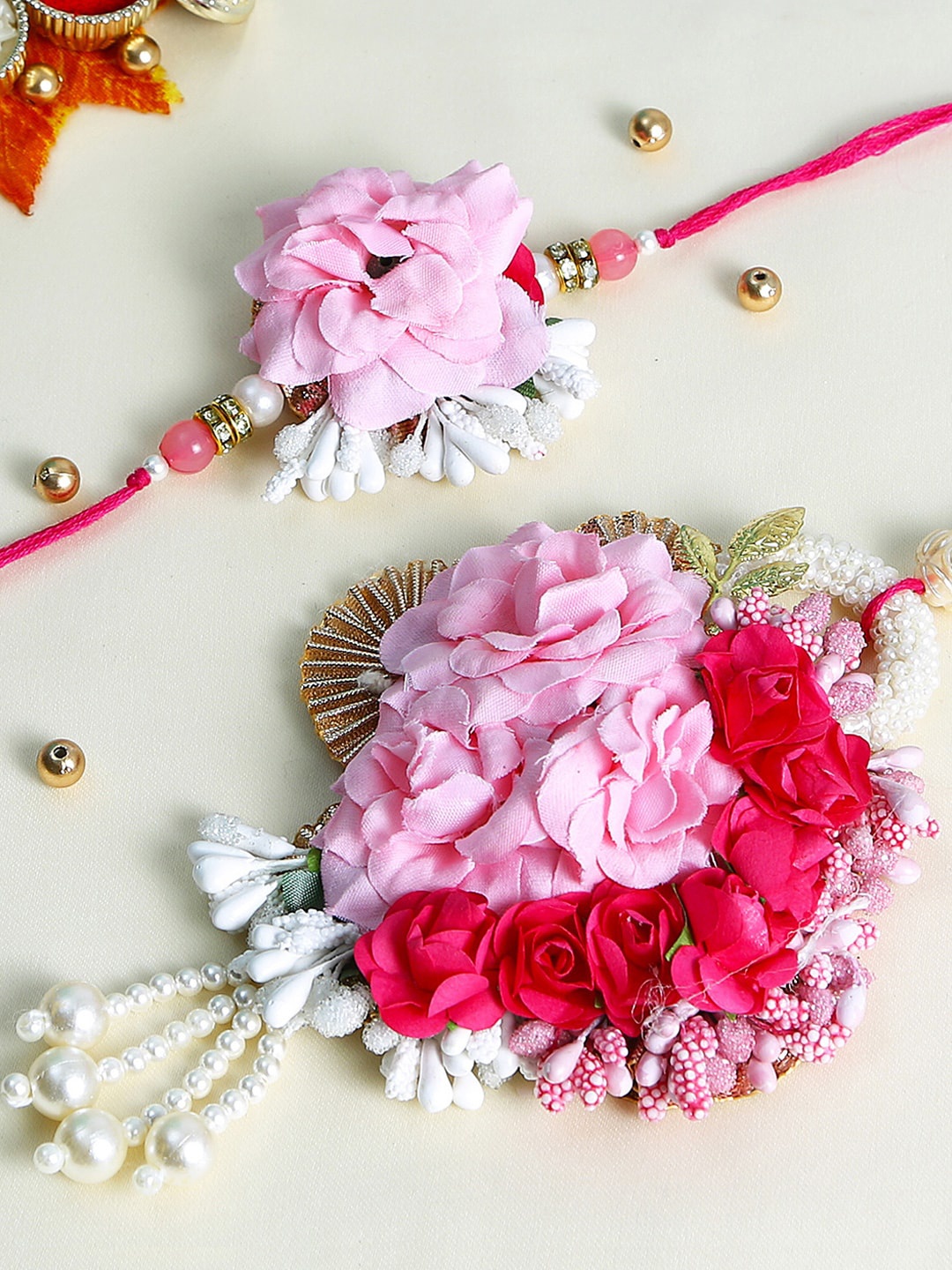 

Aapno Rajasthan Set Of 2 Pink & White Pearl Floral designed Rakhi