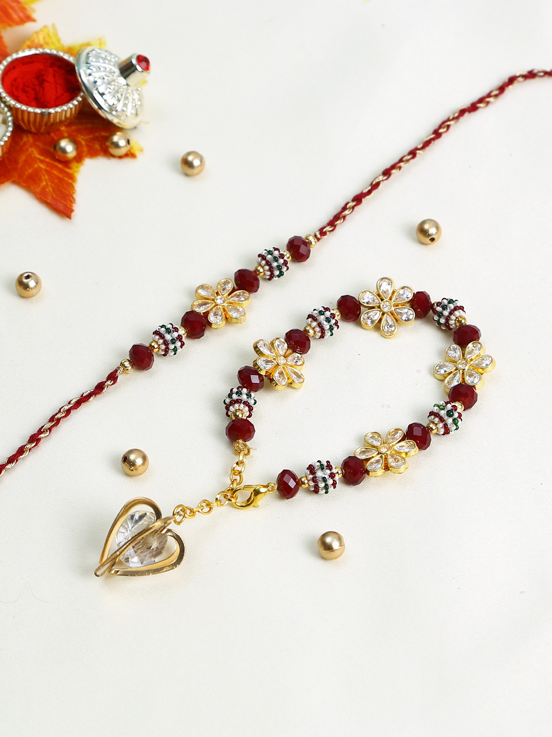 

Aapno Rajasthan Maroon & Gold Beaded Bhaiya Bhabhi Rakhi Set