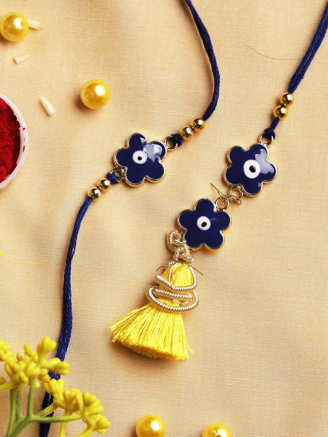 

Aapno Rajasthan Set Of 2 Blue & Golden Evil-Eye Rakhi & Lumba & Greeting Card