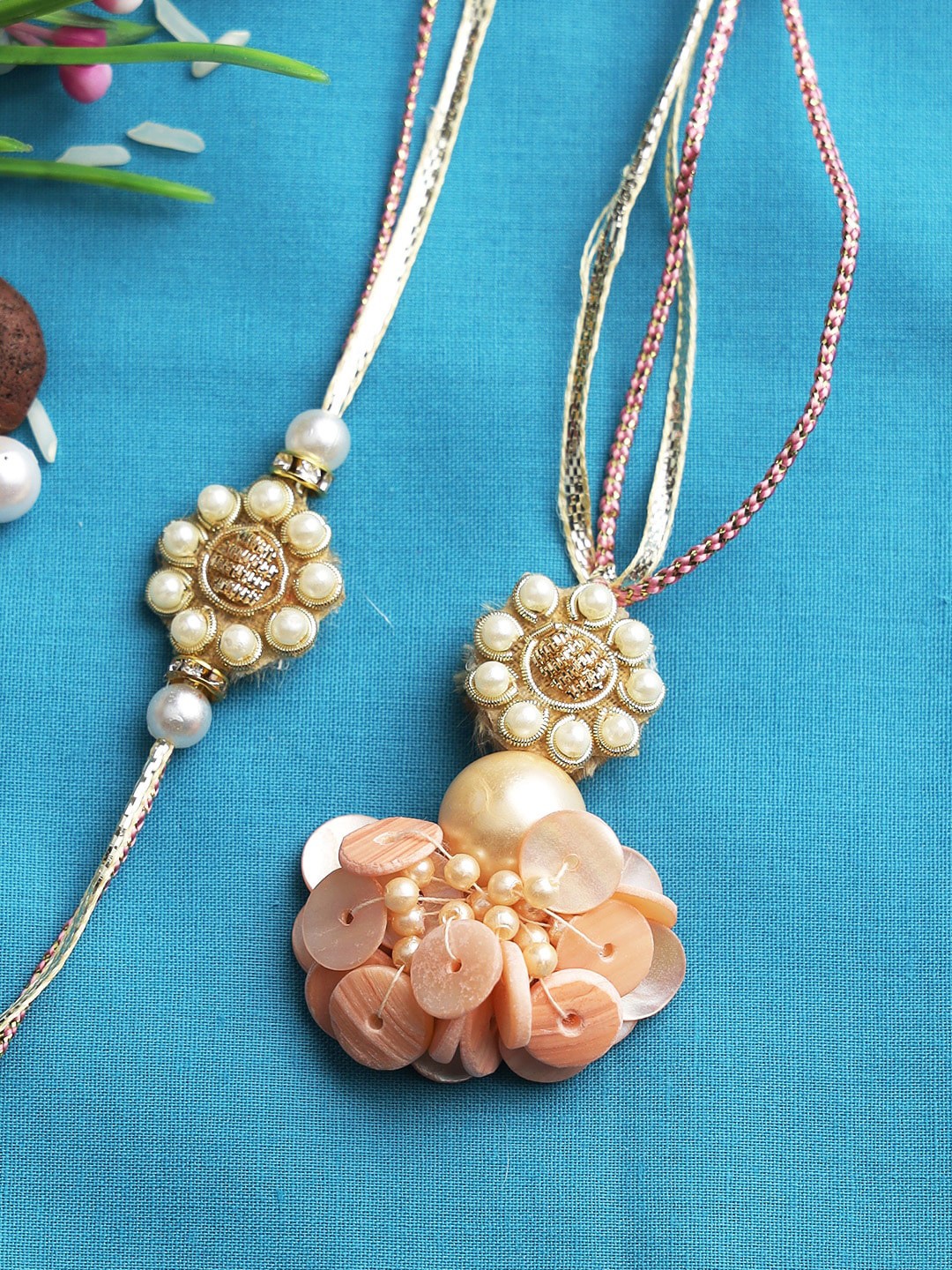 

Aapno Rajasthan Peach Pearl Beaded Bhaiya Bhabhi Rakhi Set