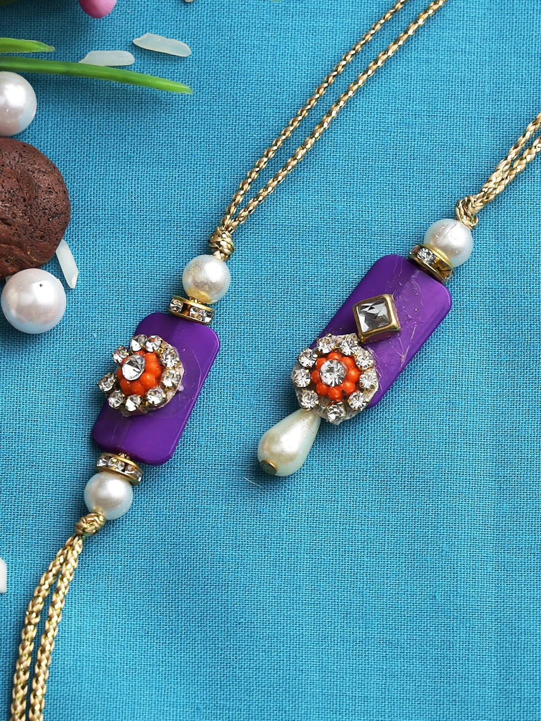 

Aapno Rajasthan Set Of 2 Purple & Gold-Coloured Beaded Rakhi With Box
