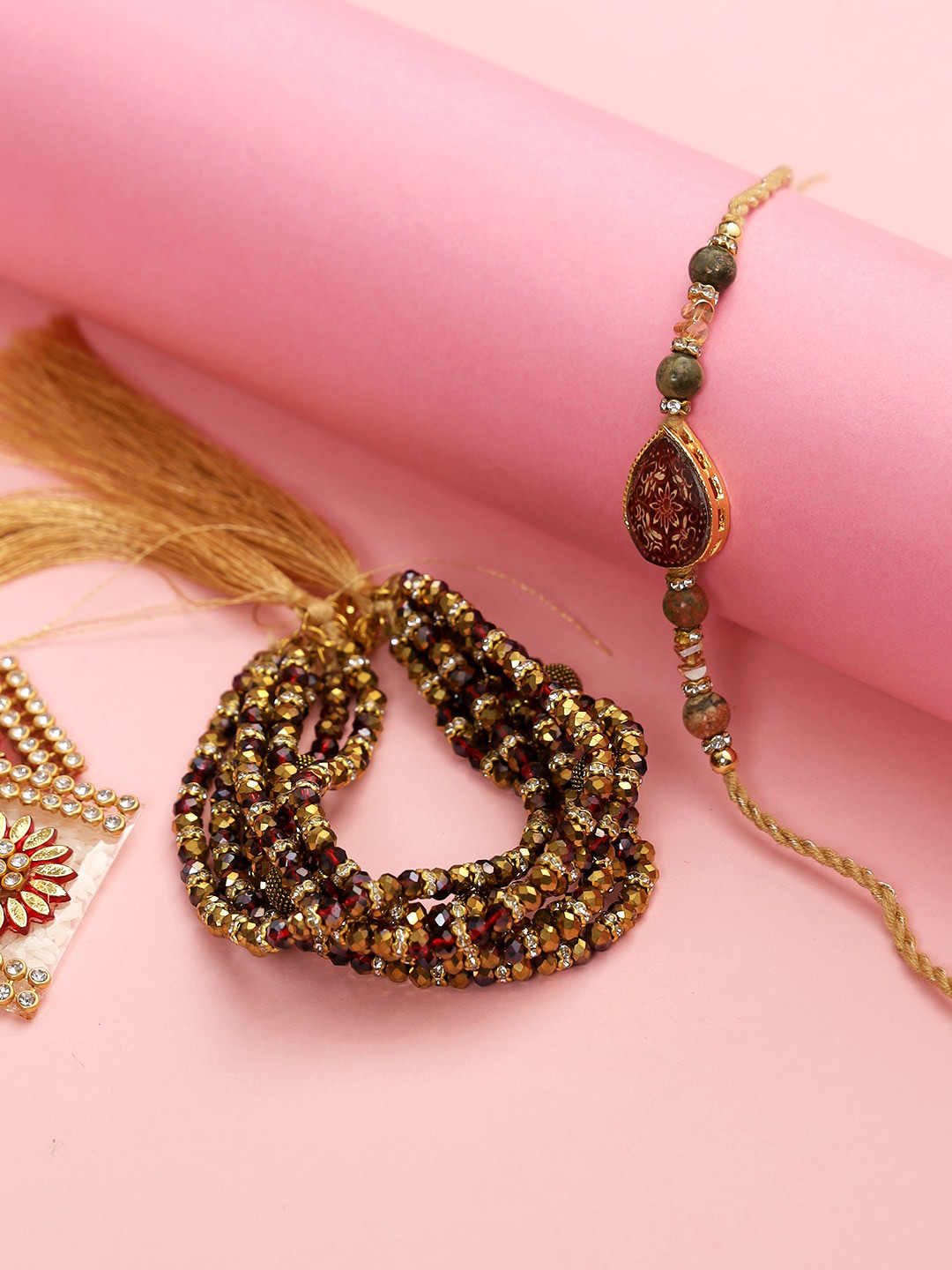 

Aapno Rajasthan Gold-Toned & Red Beaded Bhaiya Bhabhi Rakhi Combo Set